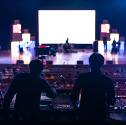 Blur image of sound engineer team working to prepare for music concert stage.