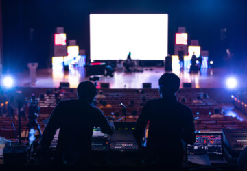 Blur image of sound engineer team working to prepare for music concert stage.